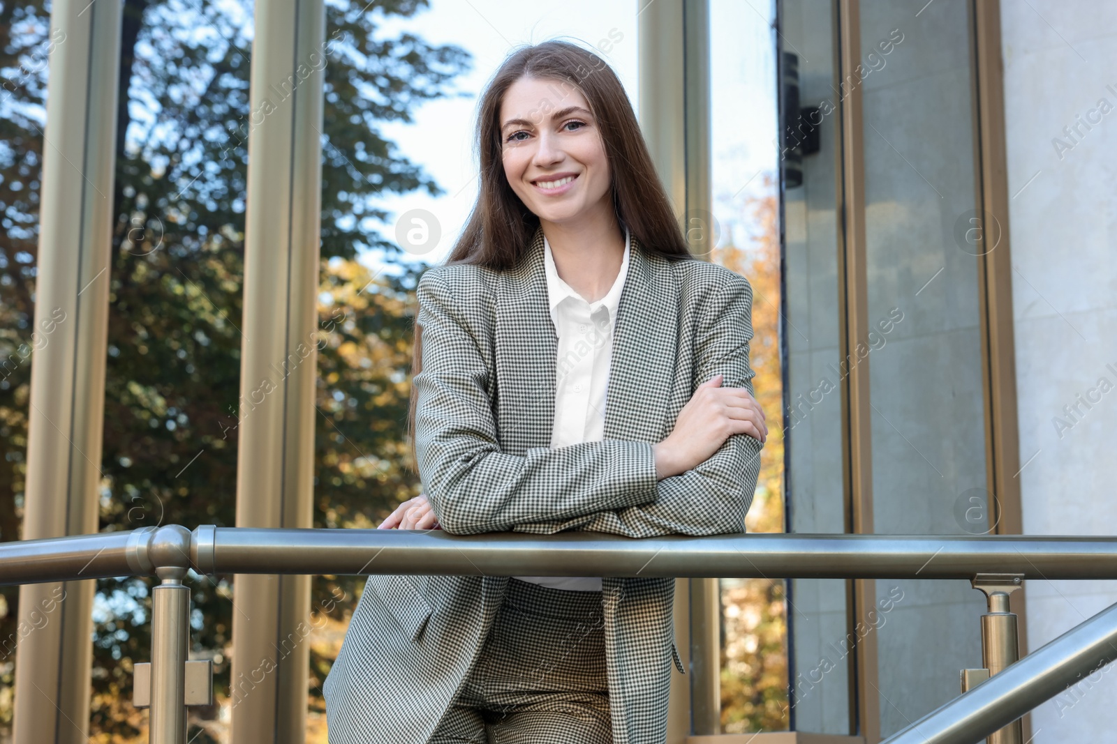 Photo of Portrait of young woman wearing stylish suit outdoors