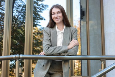 Photo of Portrait of young woman wearing stylish suit outdoors