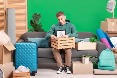 Photo of Happy man with different stuff in new apartment. Housewarming party