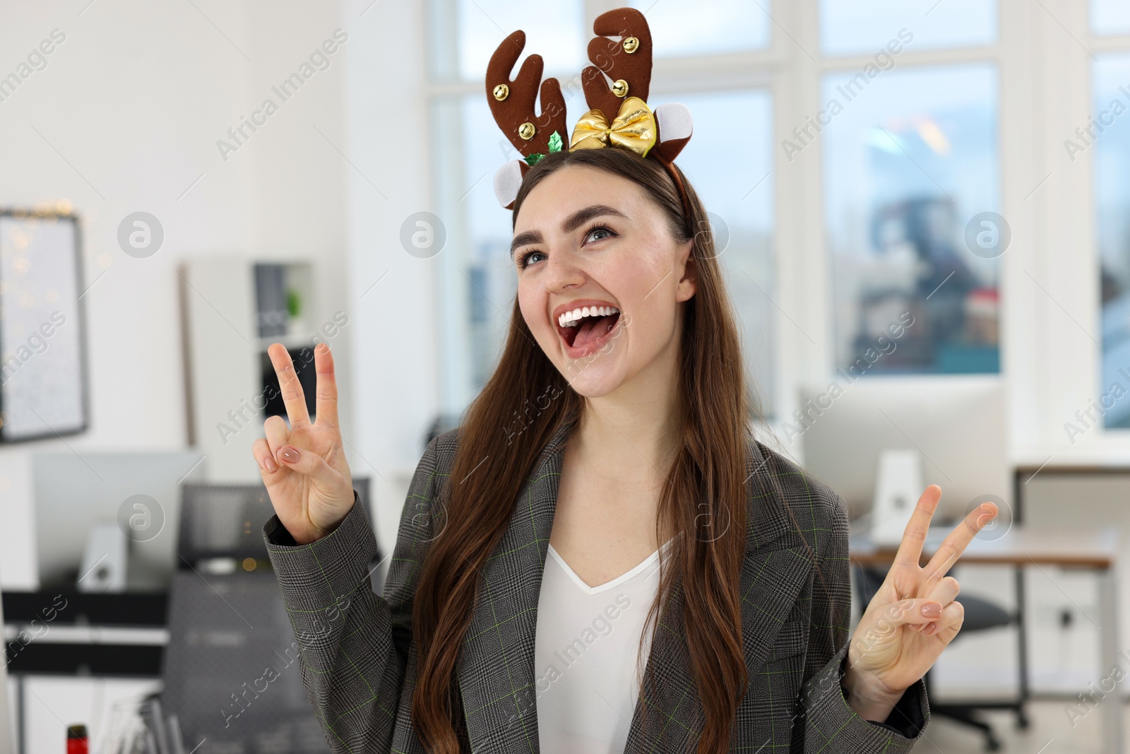 Photo of Cheerful woman having fun at office Christmas party