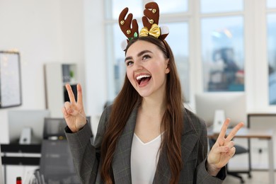 Photo of Cheerful woman having fun at office Christmas party