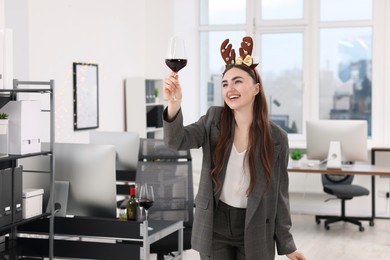 Photo of Cheerful woman with glass of wine having fun at office Christmas party