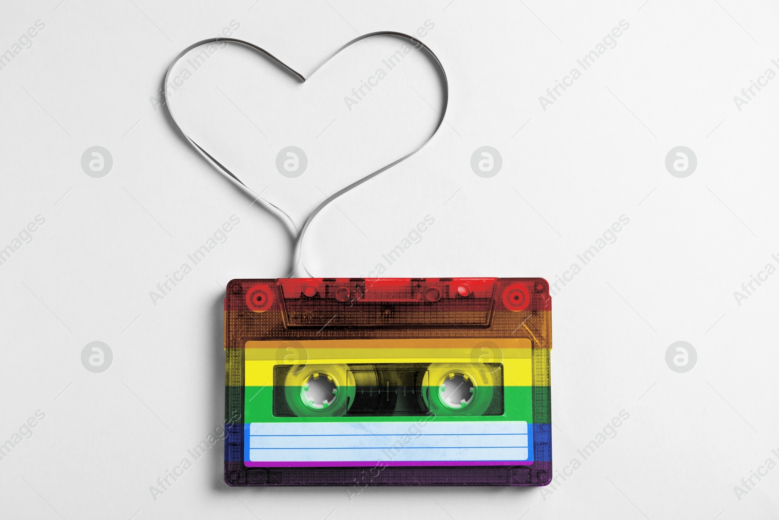 Image of Music cassette in LGBT colors and heart made with tape on white background, top view. Tolerance and acceptance