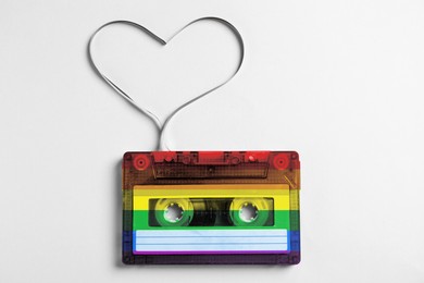 Image of Music cassette in LGBT colors and heart made with tape on white background, top view. Tolerance and acceptance