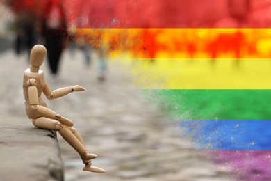 Wooden human figure sitting on curb outdoors and LGBT flag, double exposure. Tolerance and acceptance