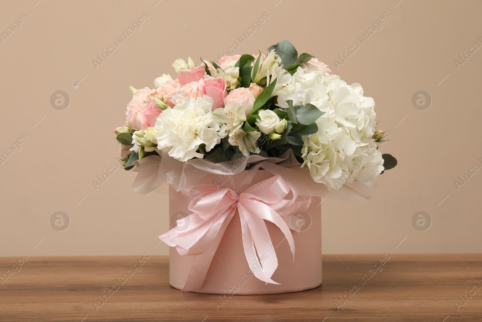 Photo of Bouquet of beautiful flowers on wooden table