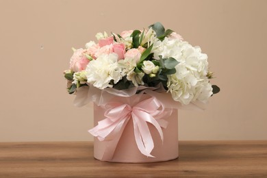 Photo of Bouquet of beautiful flowers on wooden table