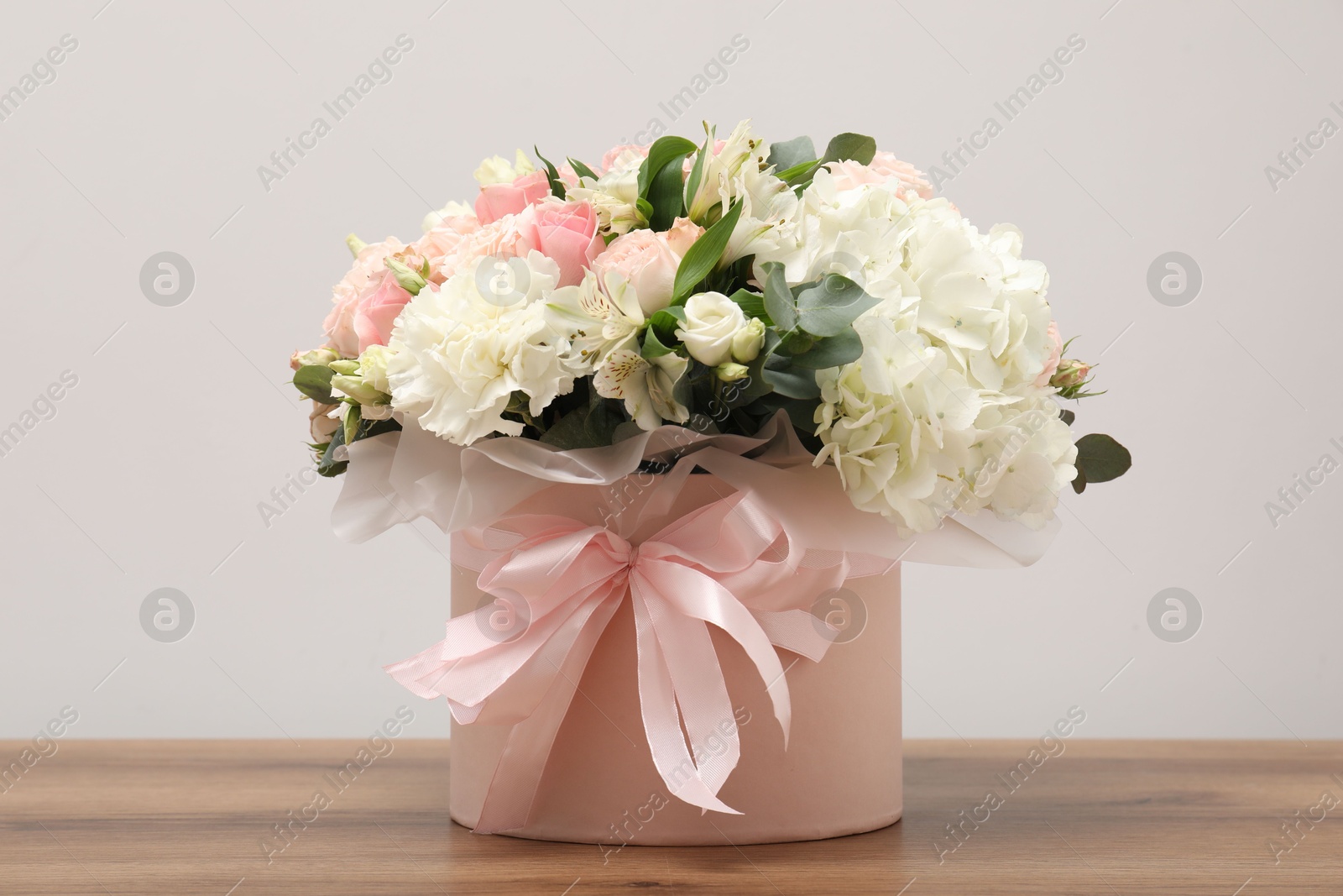 Photo of Bouquet of beautiful flowers on wooden table