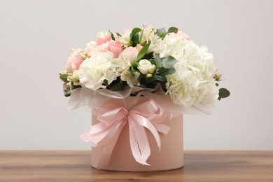 Photo of Bouquet of beautiful flowers on wooden table