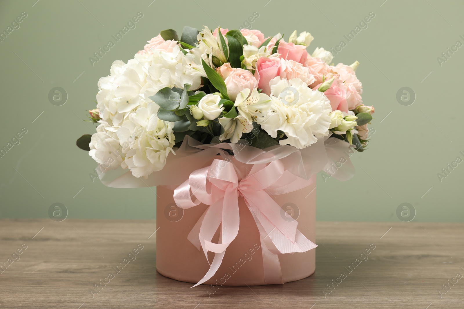 Photo of Bouquet of beautiful flowers on wooden table