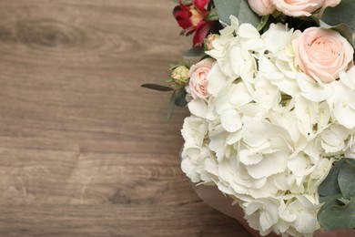 Photo of Bouquet of beautiful flowers on wooden table, top view. Space for text