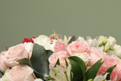 Photo of Bouquet of beautiful flowers on green background, closeup