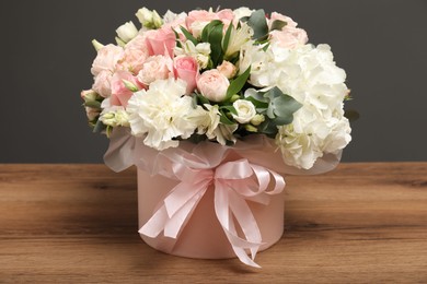 Photo of Bouquet of beautiful flowers on wooden table