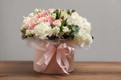 Photo of Bouquet of beautiful flowers on wooden table