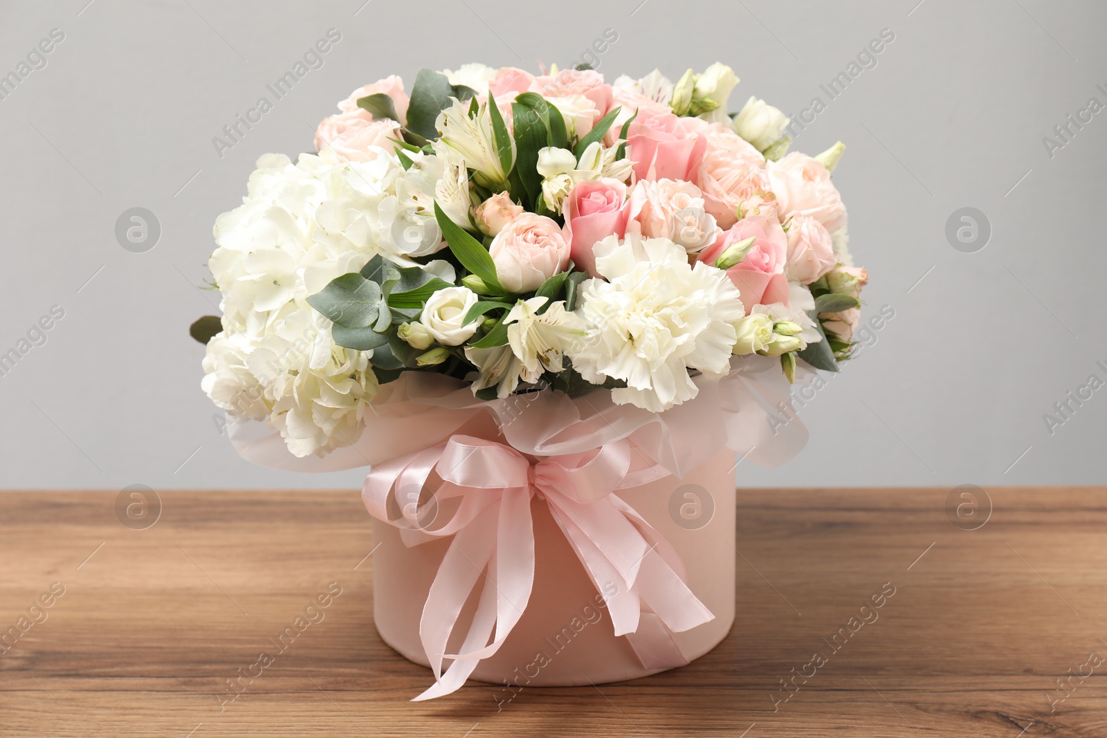 Photo of Bouquet of beautiful flowers on wooden table