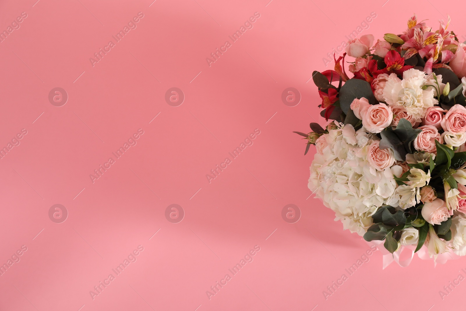 Photo of Bouquet of beautiful flowers on pink background, top view. Space for text