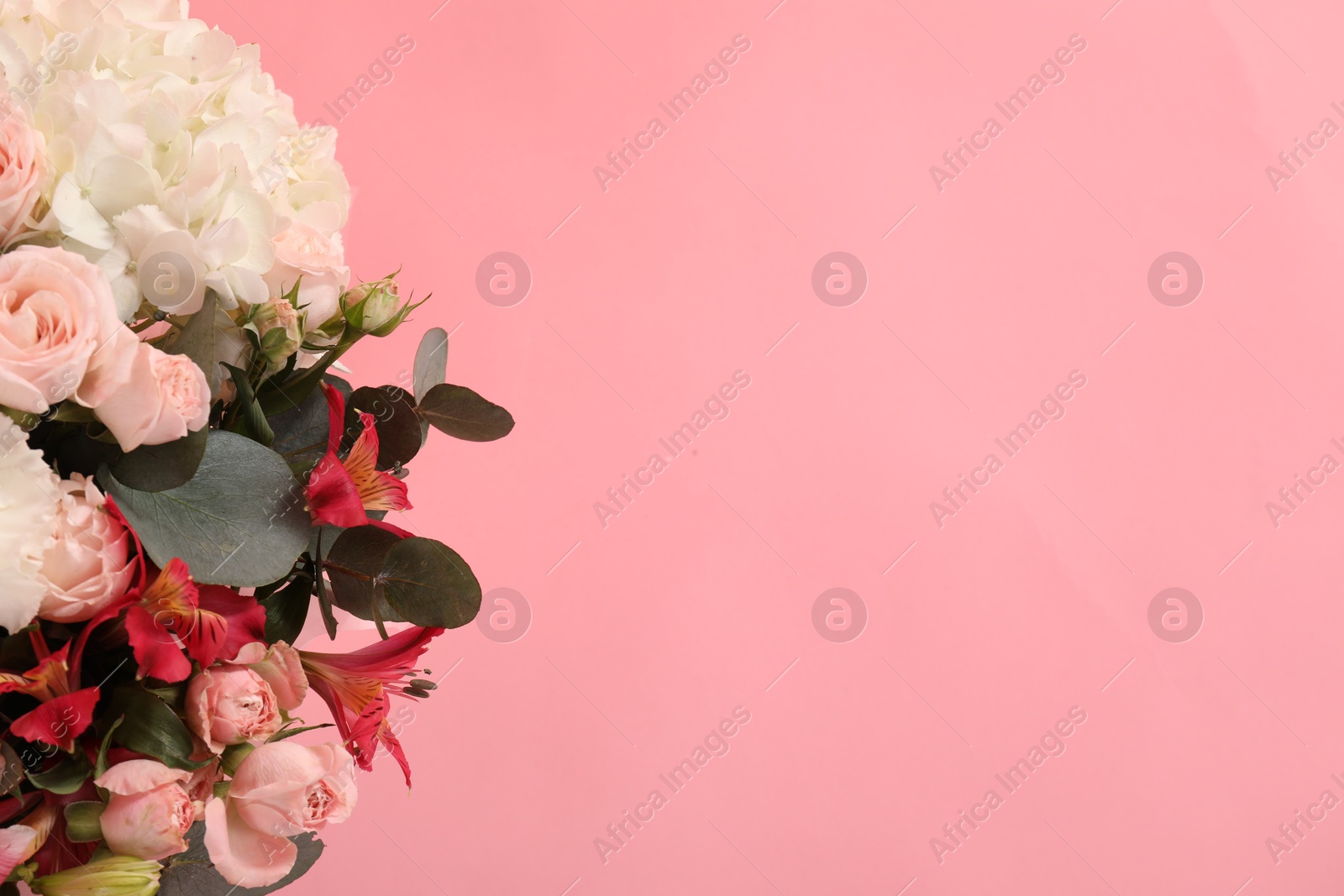 Photo of Bouquet of beautiful flowers on pink background, top view. Space for text