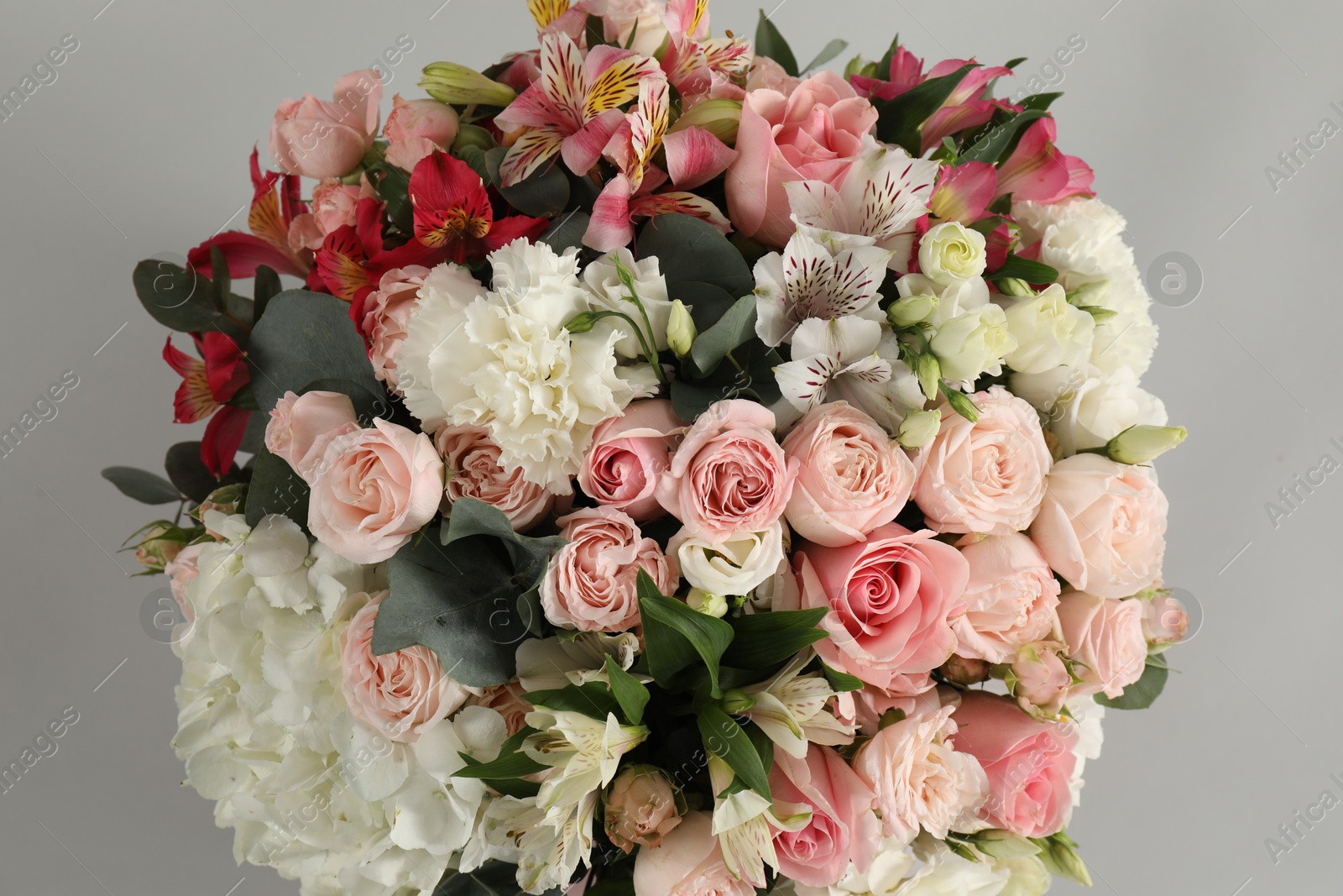 Photo of Bouquet of beautiful flowers on grey background, top view