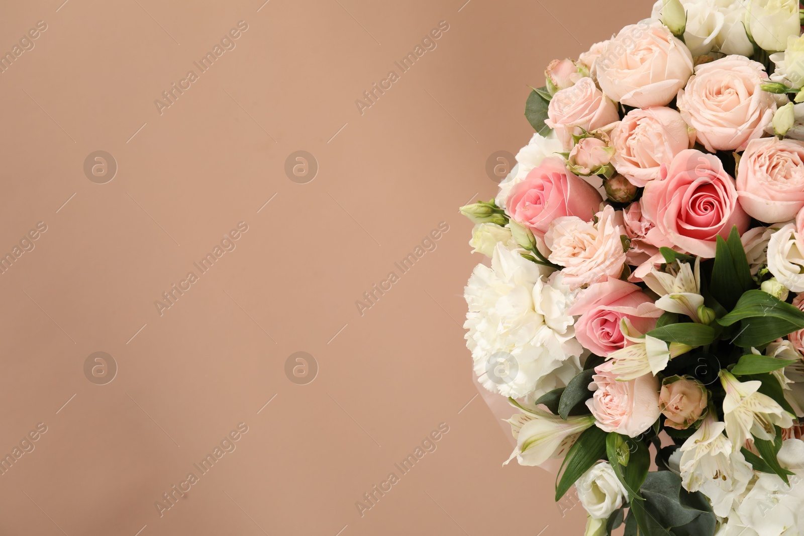 Photo of Bouquet of beautiful flowers on beige background, top view. Space for text