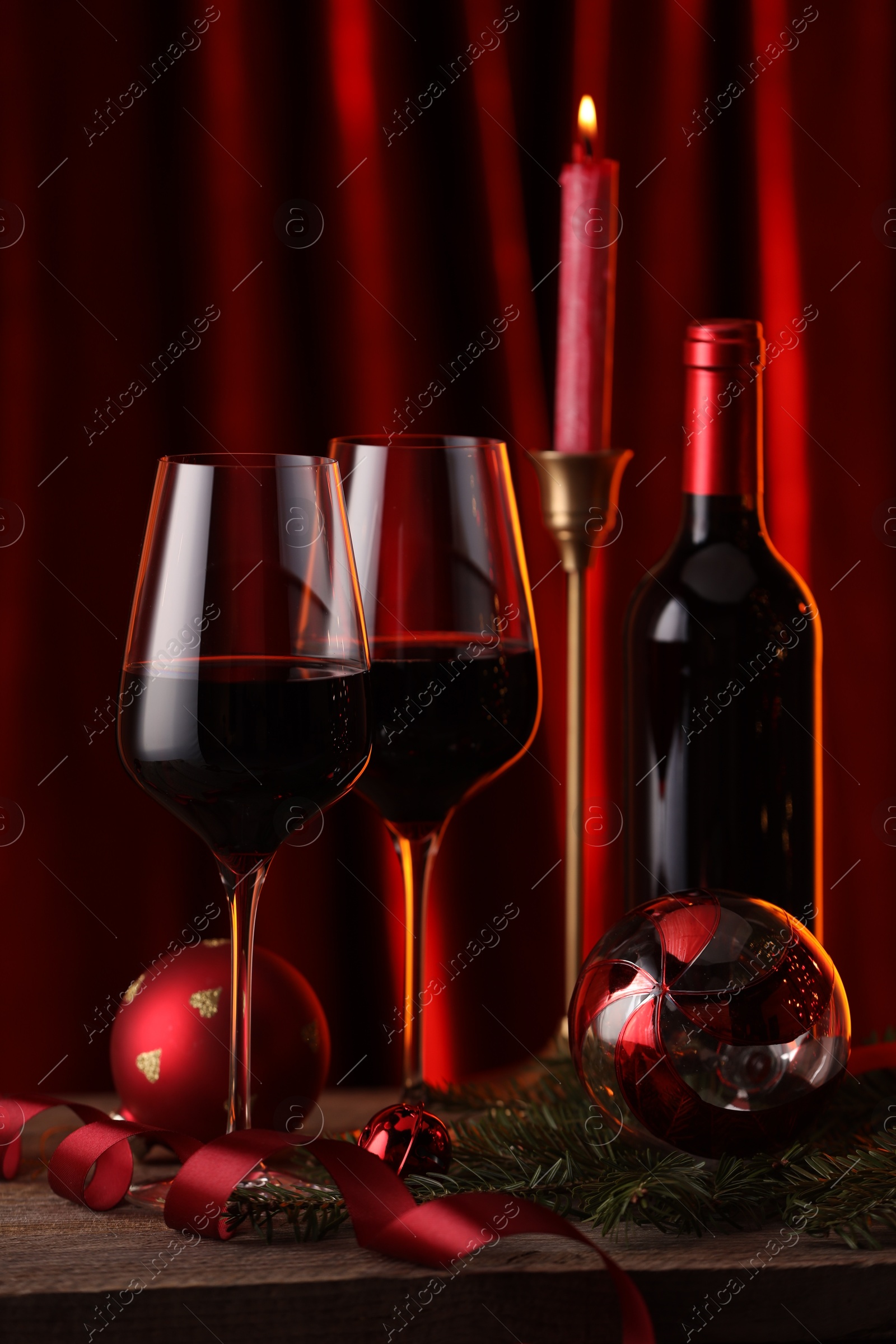 Photo of Red wine and Christmas decor on wooden table