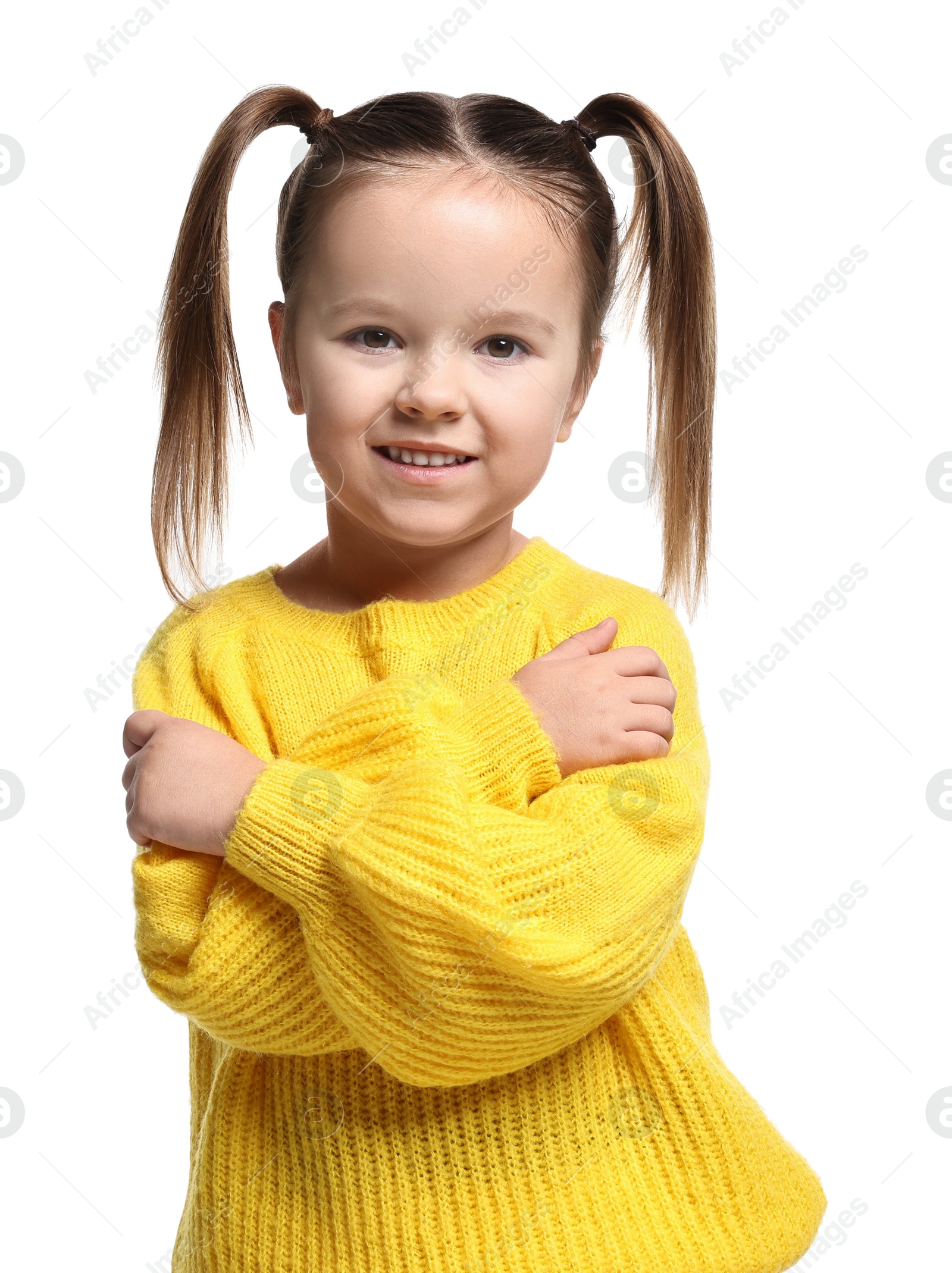 Photo of Cute little girl hugging herself on white background