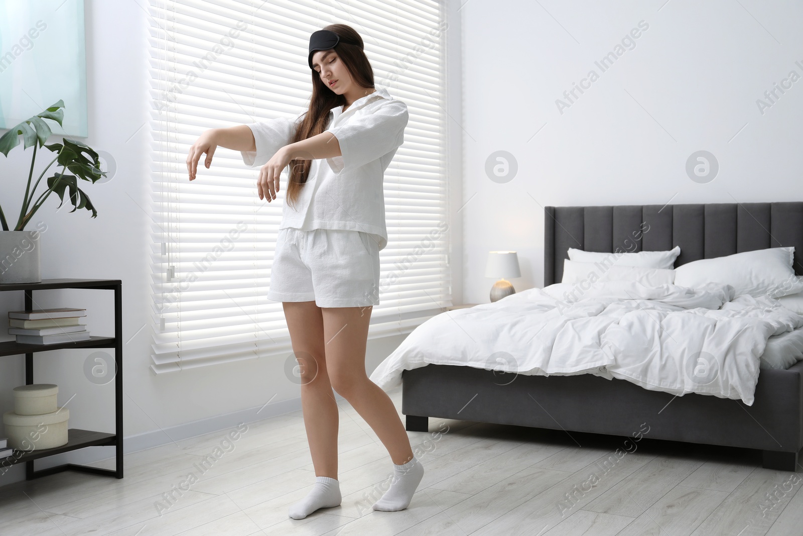 Photo of Young woman suffering from sleepwalking at home