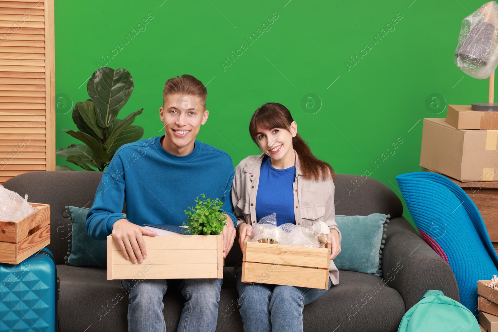 Photo of Happy couple with different stuff in new apartment. Housewarming party