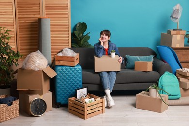 Happy woman with different stuff in new apartment. Housewarming party