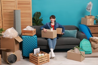 Photo of Happy woman with different stuff in new apartment. Housewarming party