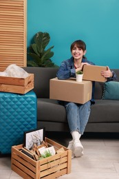 Happy woman with different stuff in new apartment. Housewarming party