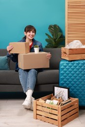 Happy woman with different stuff in new apartment. Housewarming party