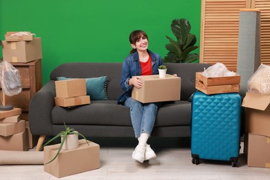 Photo of Happy woman with different stuff in new apartment. Housewarming party