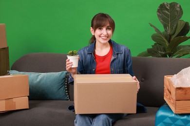 Photo of Happy woman with different stuff in new apartment. Housewarming party