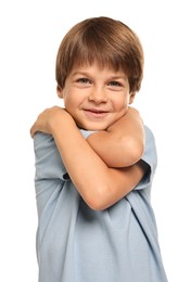 Cute little boy hugging himself on white background