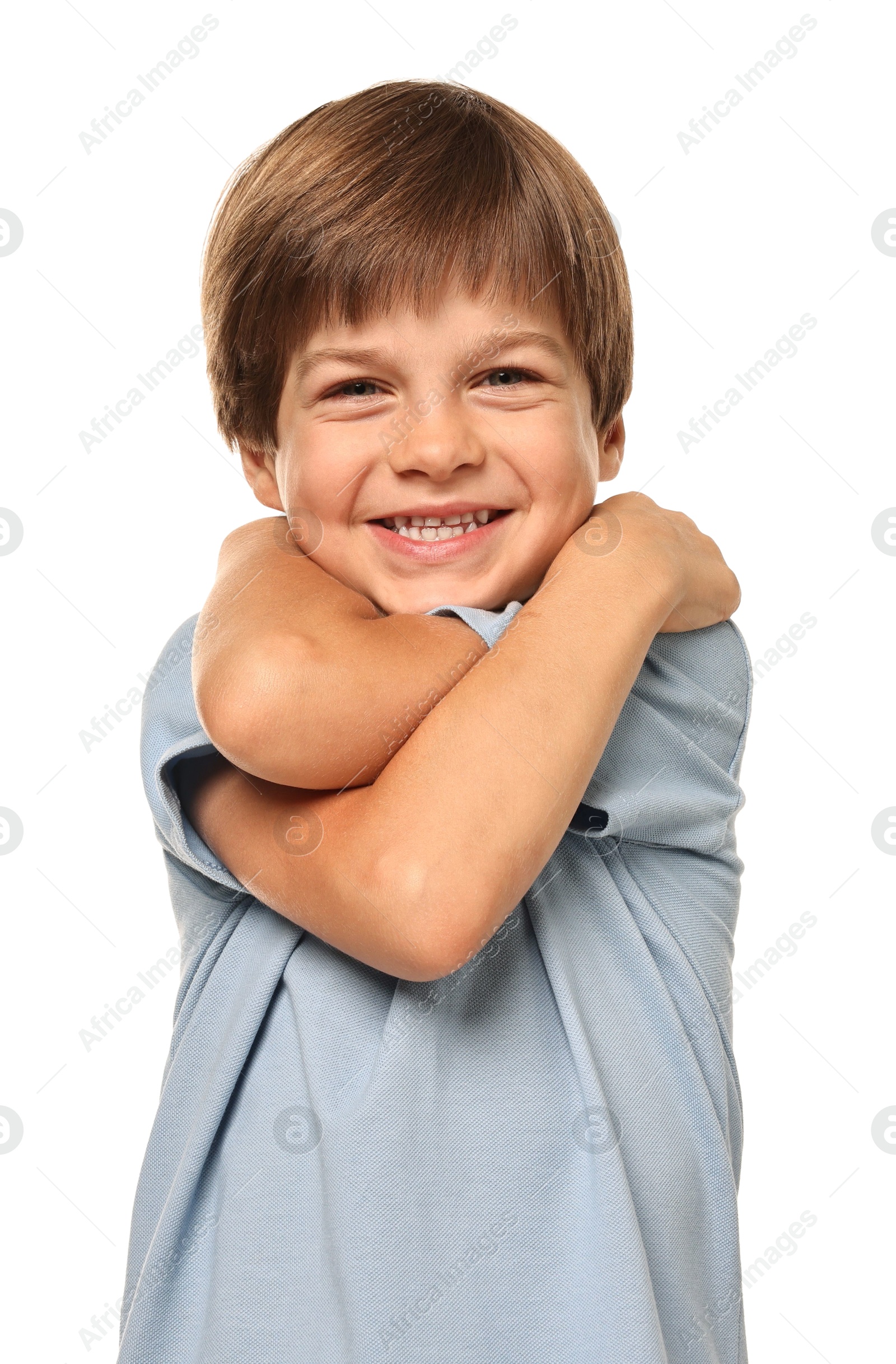 Photo of Cute little boy hugging himself on white background