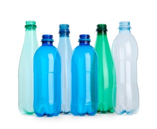 Photo of Many empty plastic bottles isolated on white