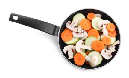 Photo of Frying pan with fresh vegetables and mushrooms isolated on white, top view