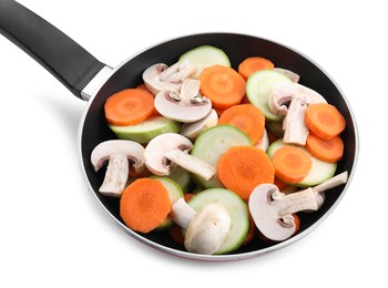 Photo of Frying pan with fresh vegetables and mushrooms isolated on white