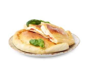 Photo of Pieces of delicious calzone pizza with mozzarella, tomatoes and basil isolated on white