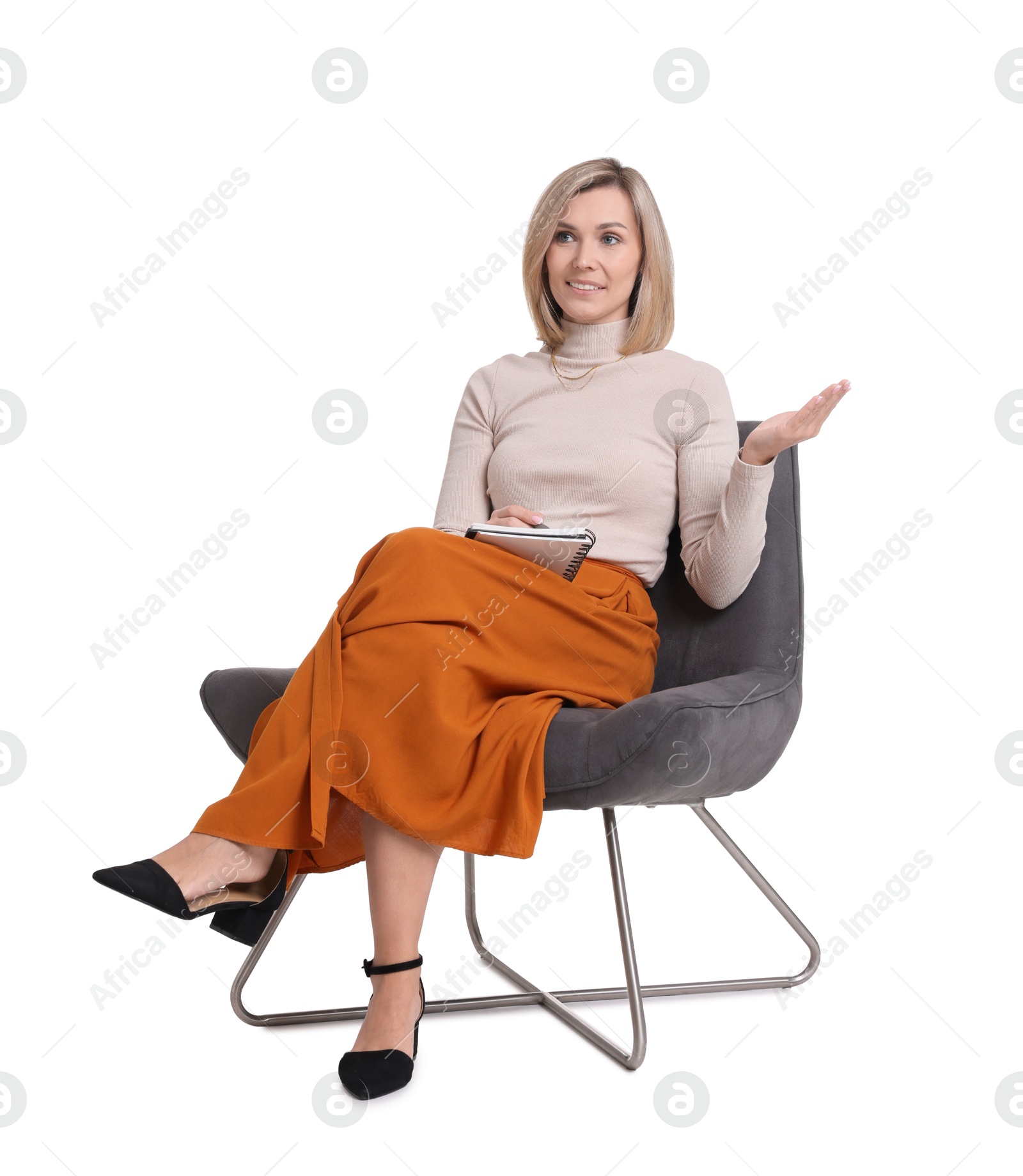 Photo of Professional psychologist with notebook sitting on chair against white background