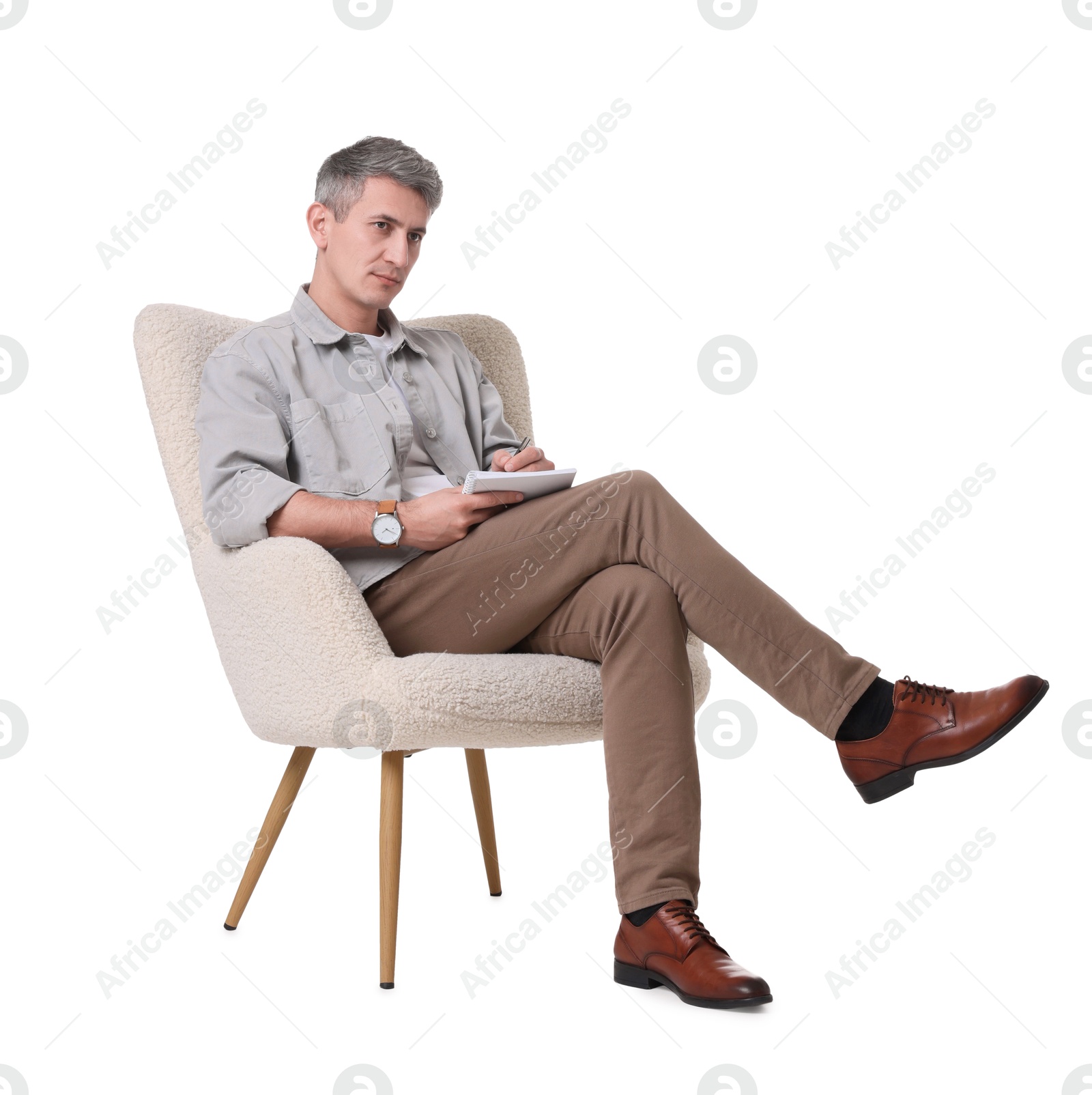 Photo of Professional psychologist with notebook sitting on chair against white background