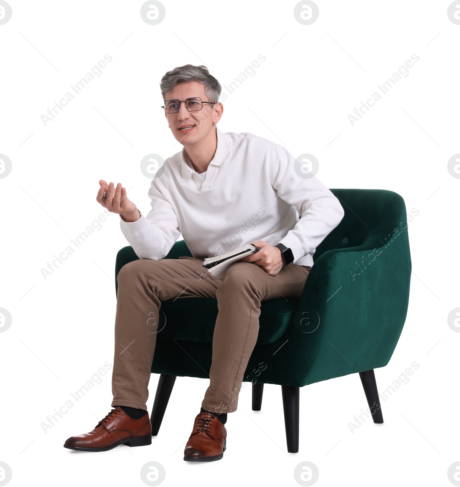 Photo of Professional psychologist with notebook sitting on chair against white background