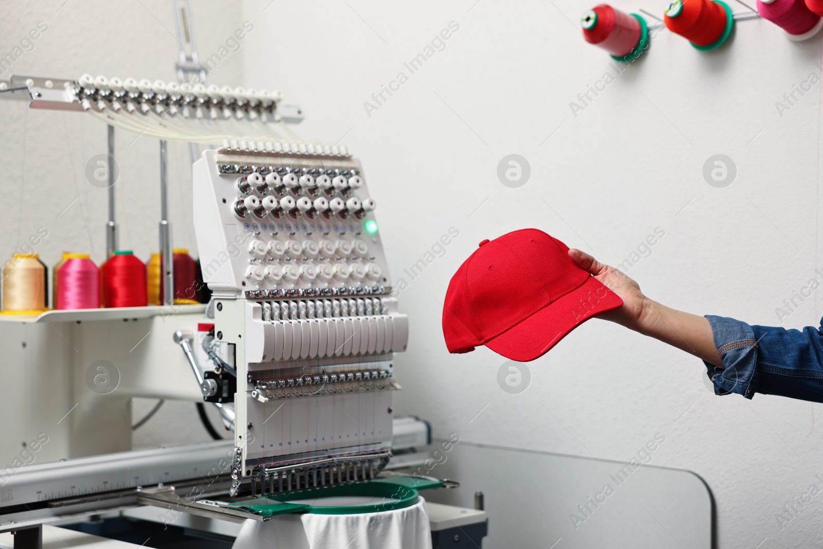 Photo of Woman with blank baseball cap for print indoors, closeup