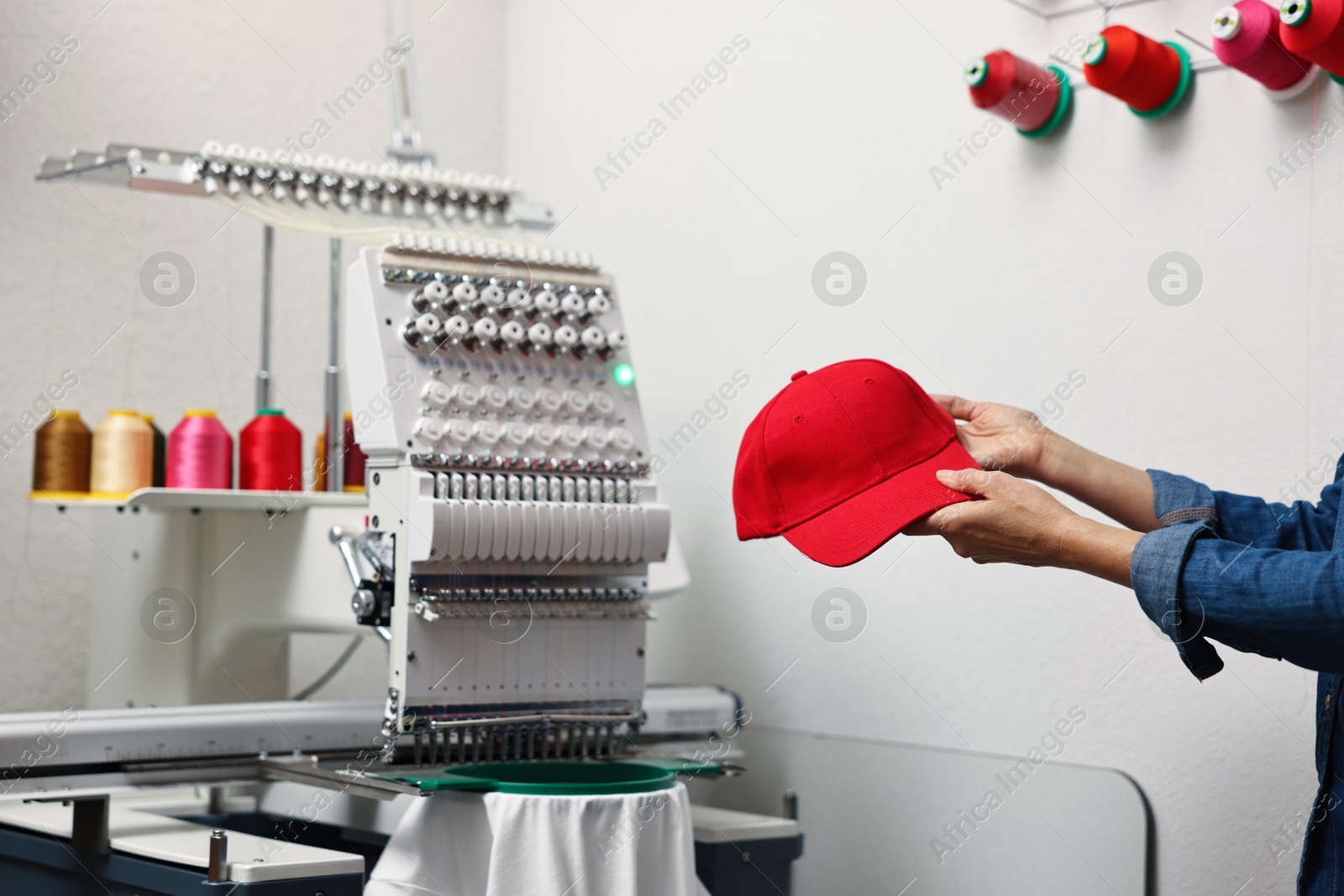 Photo of Woman with blank baseball cap for print indoors, closeup