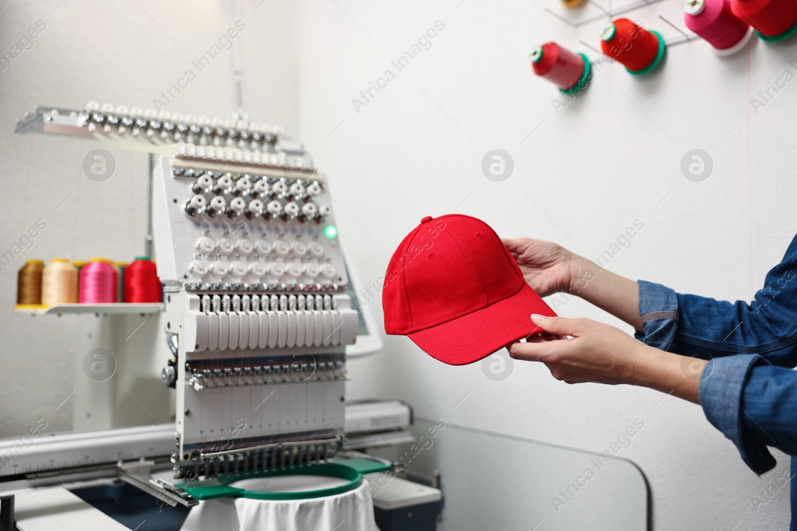 Photo of Woman with blank baseball cap for print indoors, closeup