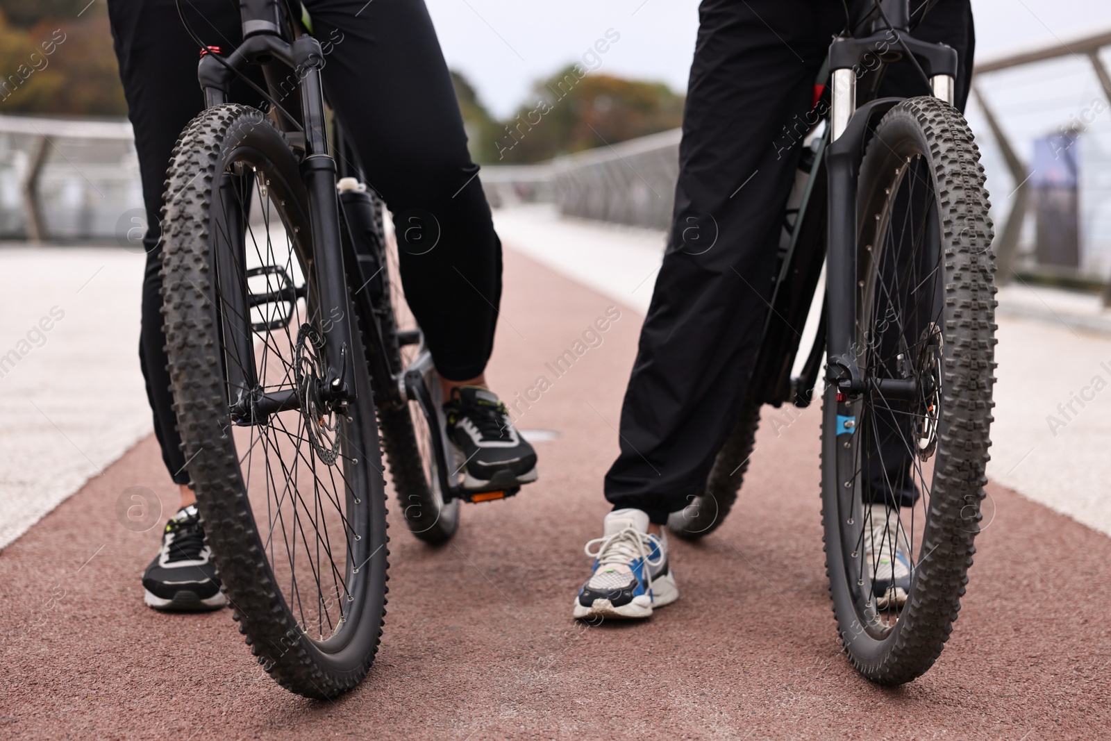 Photo of Couple with bicycles spending time together outdoors, closeup