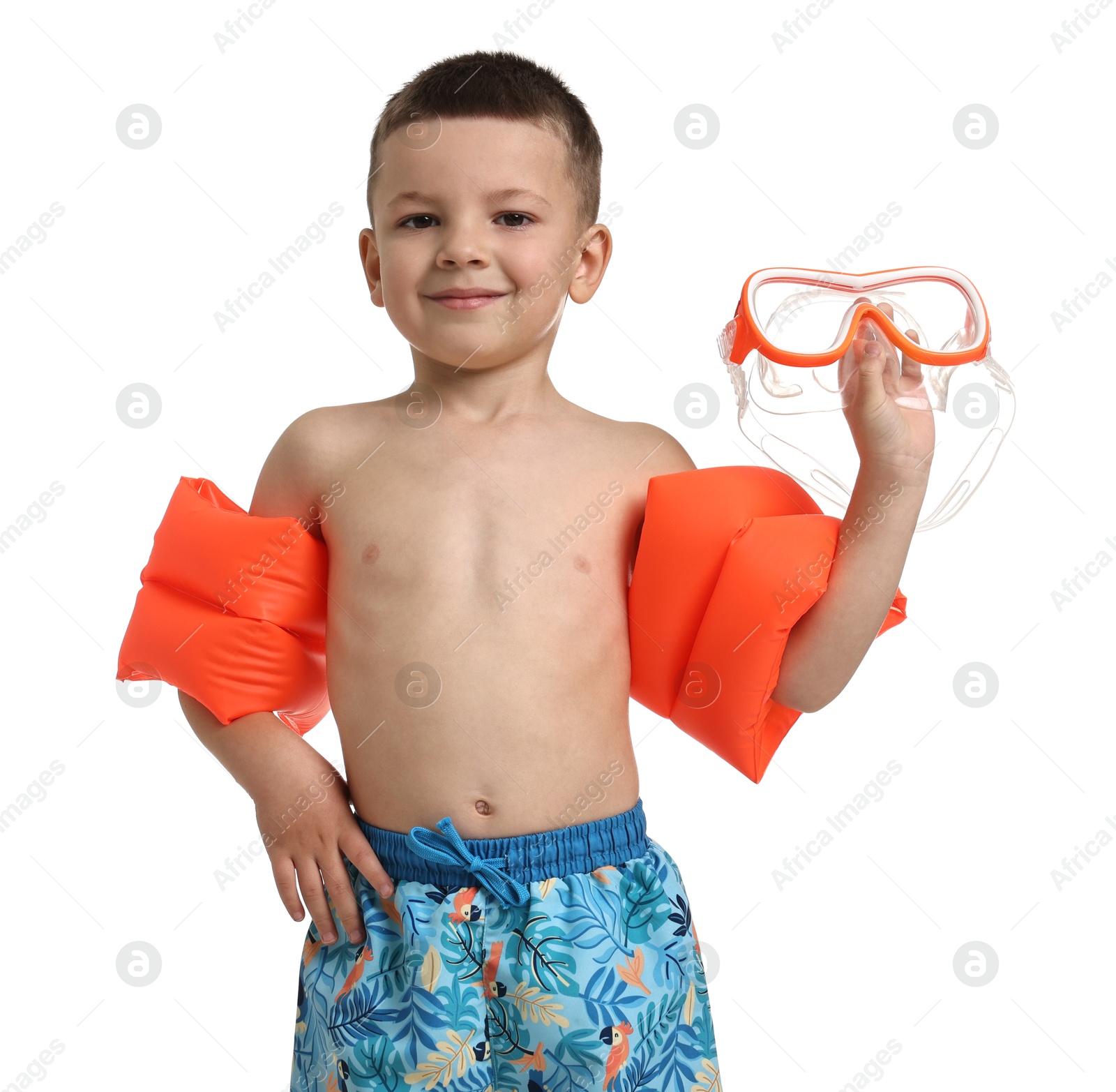 Photo of Cute little boy in beachwear with swim armbands and diving mask on white background