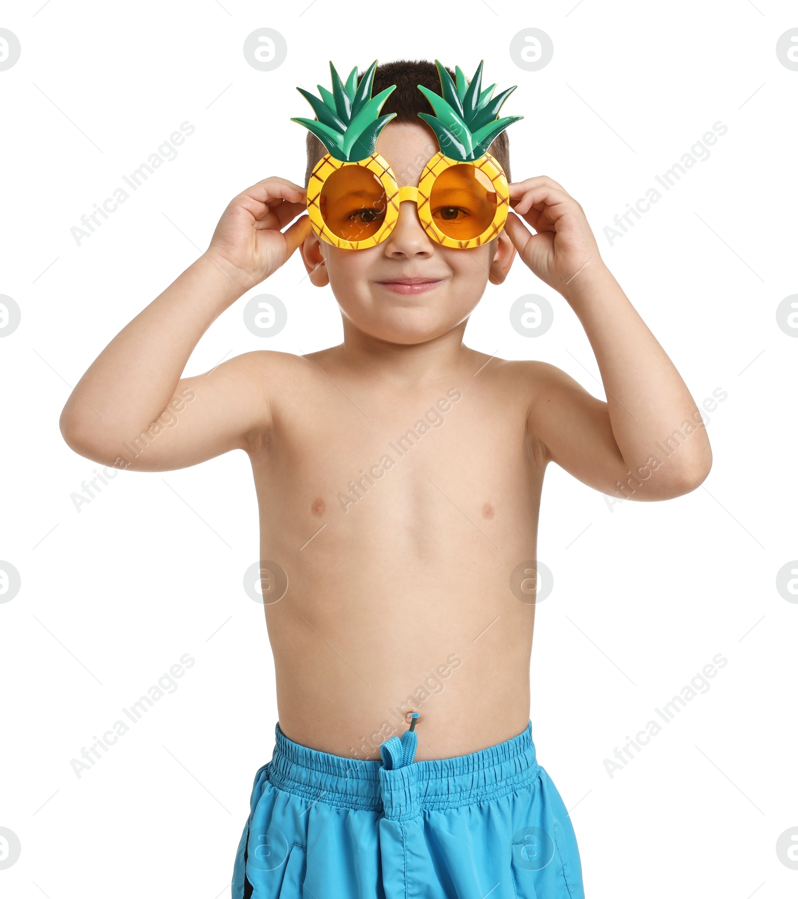 Photo of Cute little boy in beachwear with funny sunglasses on white background