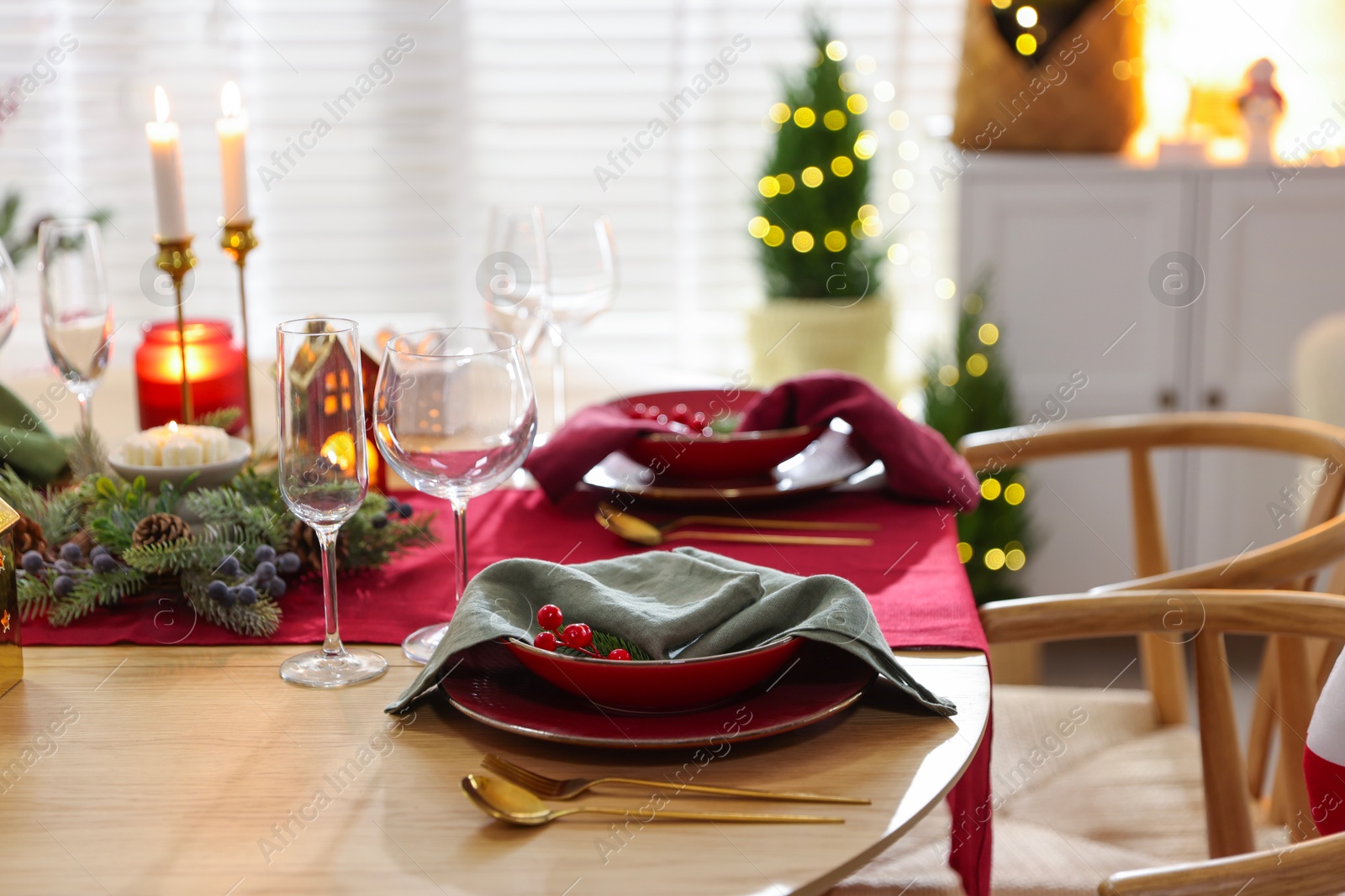 Photo of Christmas table setting with stylish dishware and festive decor indoors