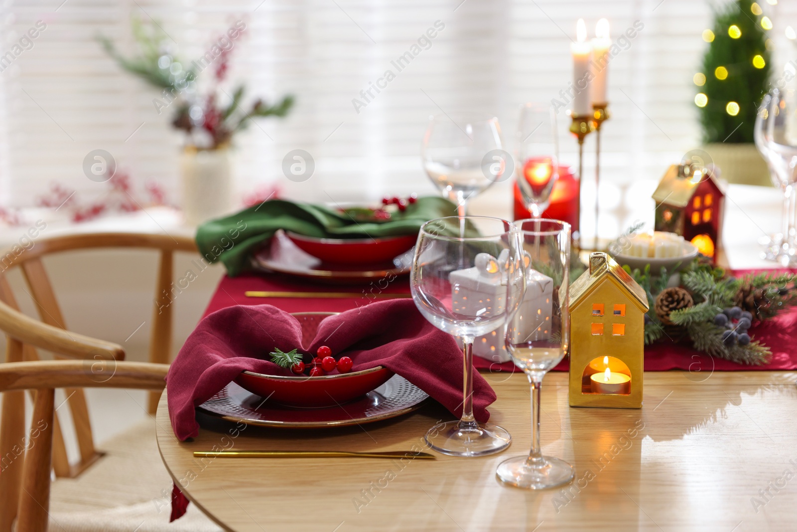 Photo of Christmas table setting with stylish dishware and festive decor indoors